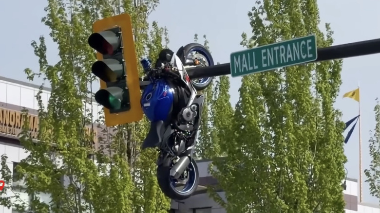Motorcycle Hangs Out After Crash Launched It On To Street Sign