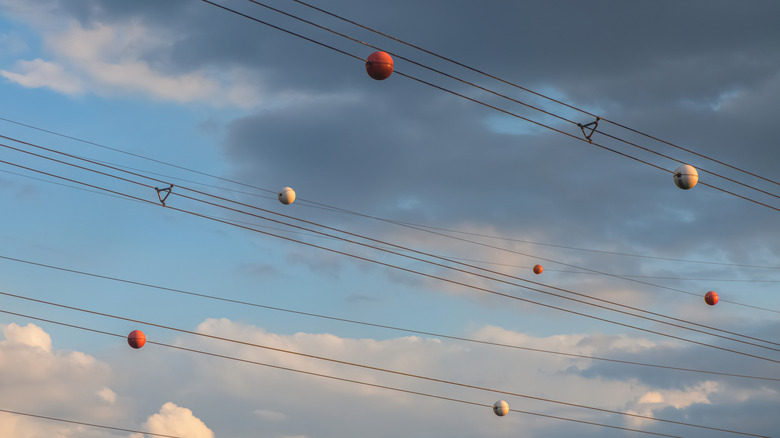 The Reason Power Lines Have Orange Balls Is Almost As Interesting As How They Get There