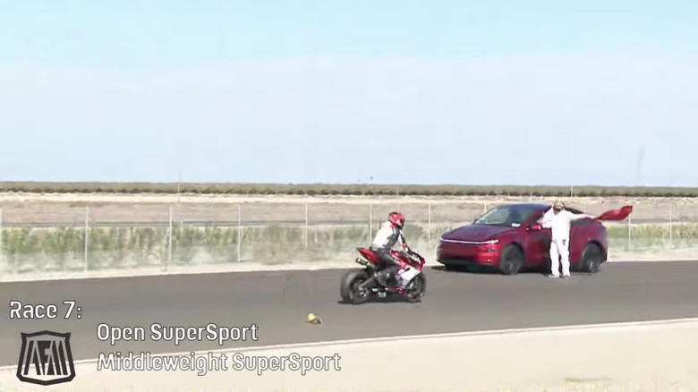 Tesla driver gets lost, drives onto track during motorcycle race