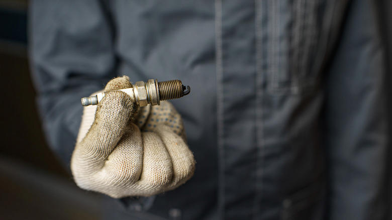 What causes spark plugs to turn black?