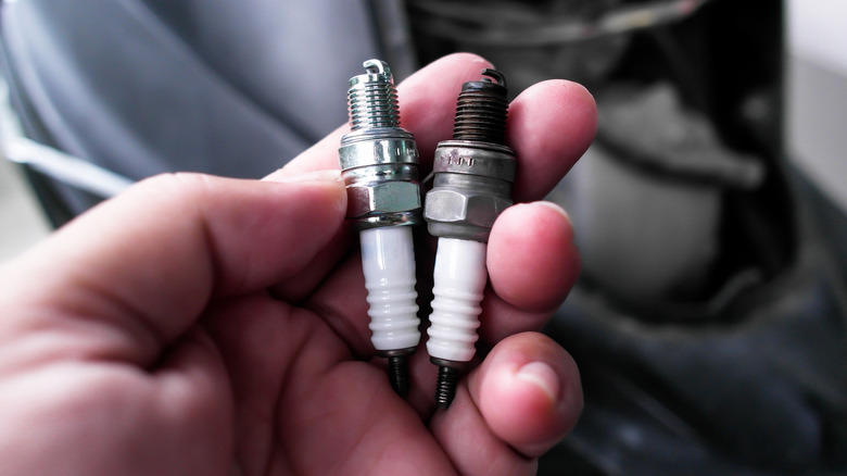 What causes spark plugs to turn black?