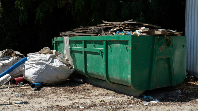 What is a roll-off truck and how is it different from a dumpster truck?