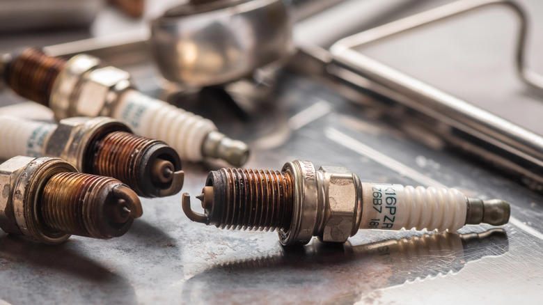 Why can't spark plugs fire when completely soaked?