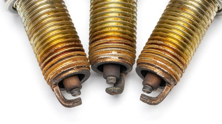 Why can't spark plugs fire when completely soaked?