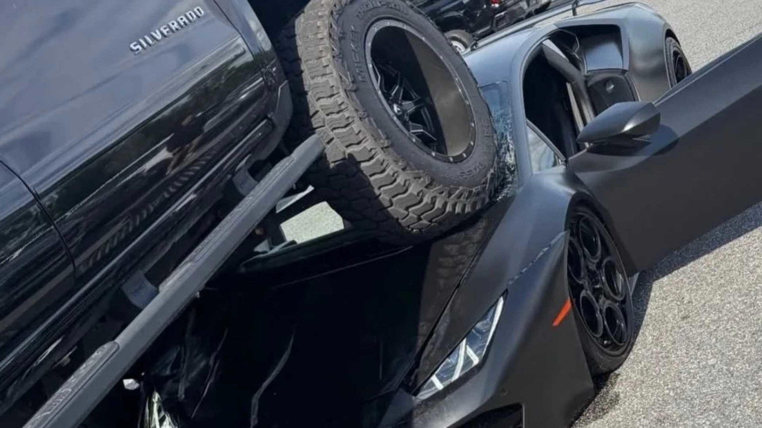 Chevy, Lamborghini, Lifted Chevy mounts $340,000 Lamborghini in parking lot accident