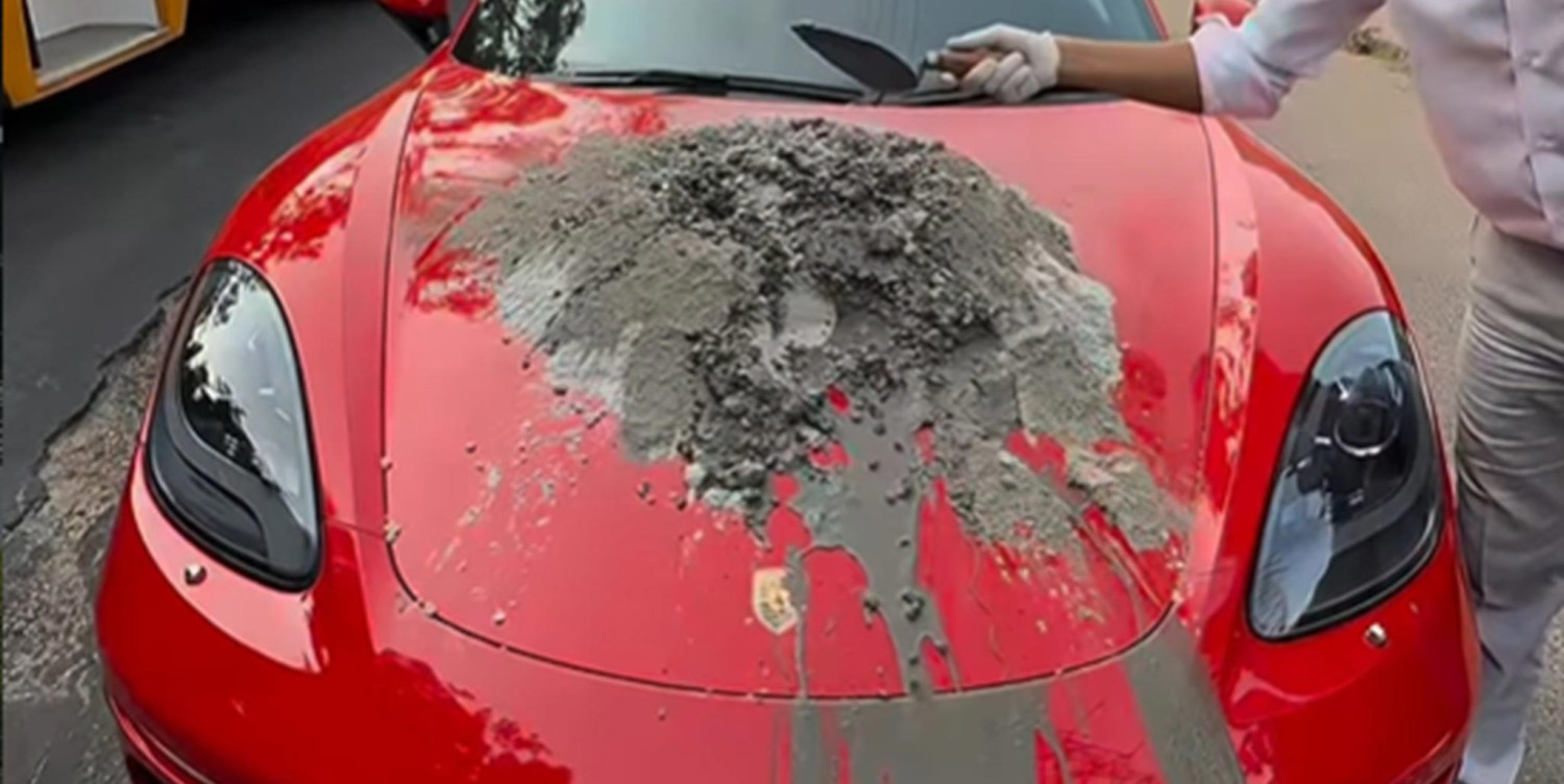 Porsche, Surrealista: Un hombre mezcla hormigón sobre el capó de su Porsche Boxster para arreglar un bache