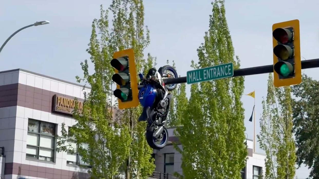 A Driver Turned And Couldn't See. Then A Motorcyce Ended Up Dangling From A Traffic Light Pole