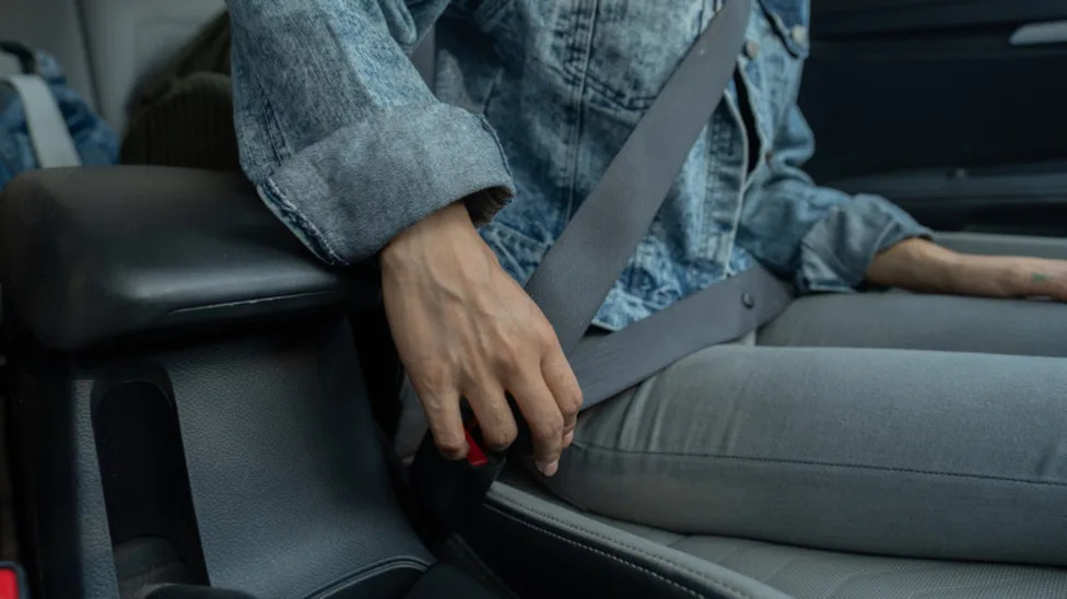 What Is That Little Button On Your Car's Seat Belts For?