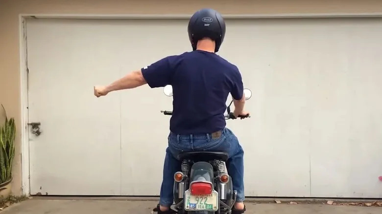 What Does It Mean When A Biker Puts Their Left Fist Out And Moves It Up And Down?