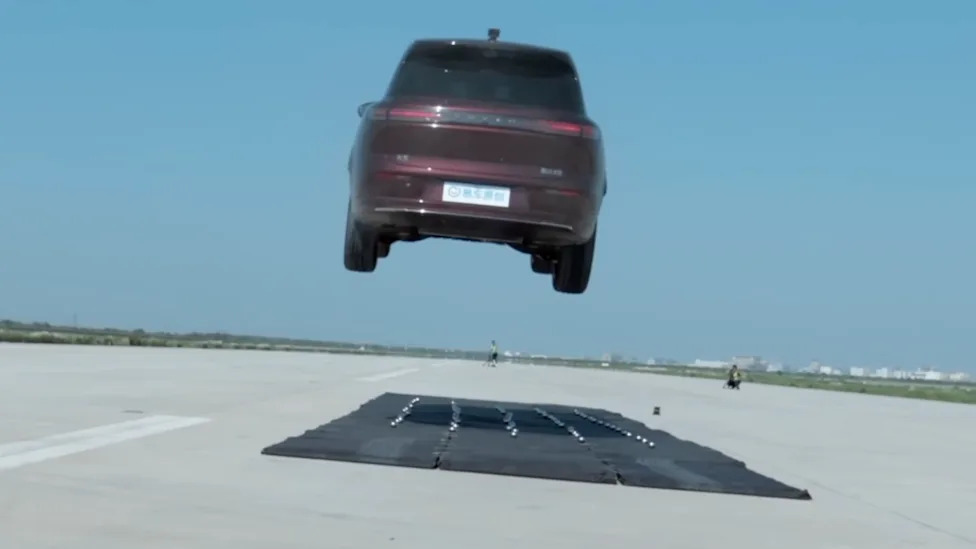 Watch: 6,000-lb Chinese Luxury EV Jumps Off a Mega Ramp and Survives