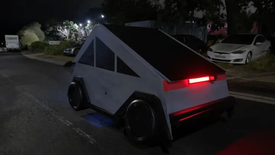 Tesla Employees React to Man Sleeping In Fake Cybertruck He Built Outside of Dealership
