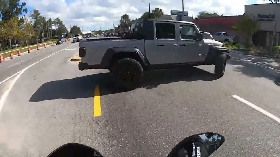 Dashcam Shows a Jeep Pulling Out Into an Intersection, Nearly Taking Out a Biker