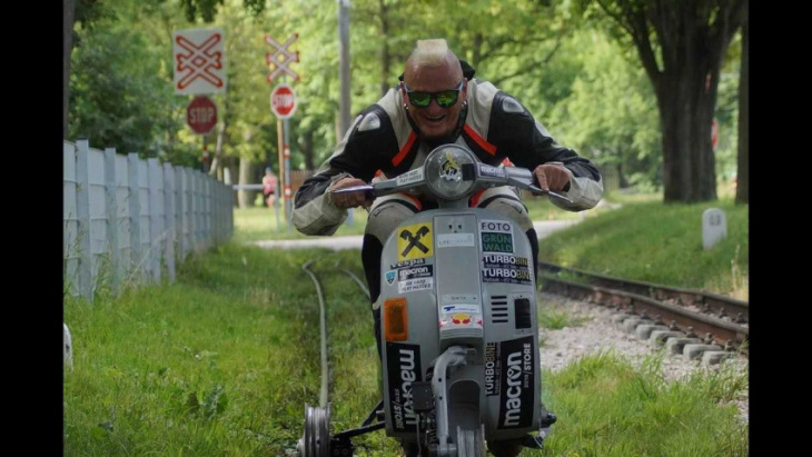 stuntman sets world record by riding vespa on railroad tracks