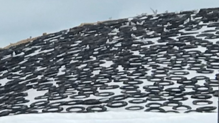 why do farms put car tires on big white tarps?