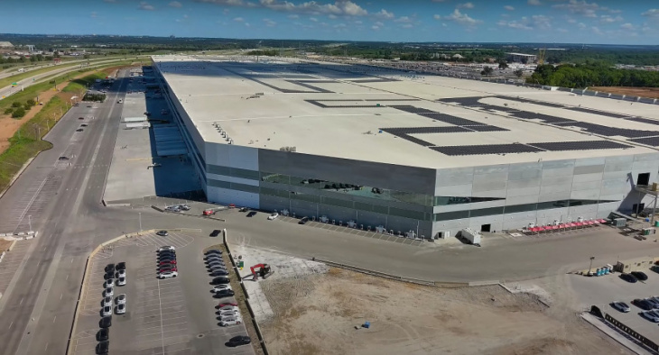 tesla giga texas facade starts getting iconic white paint, rooftop solar shows great progress