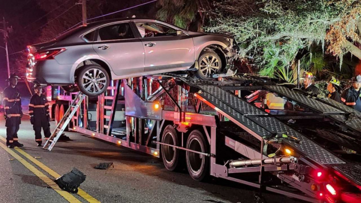 nissan maxima driver can't resist car carrier ramp, crashes near top