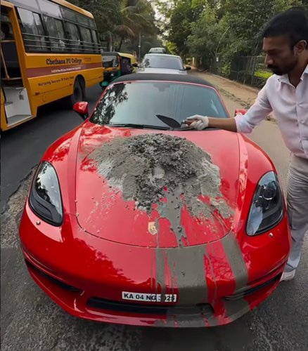 Watch This Man Mix Concrete on a Porsche Boxster's Hood to Fix a Pothole