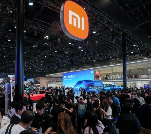 Who is defining the all-electric vehicle era?