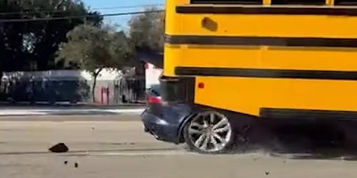 Un jaguar choca contra un autobús escolar y queda atascado debajo