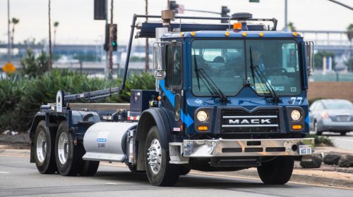 What is a roll-off truck and how is it different from a dumpster truck?