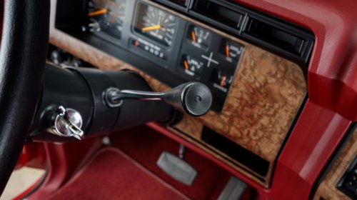 Why did most car manufacturers stop using column-mounted gear shifters?