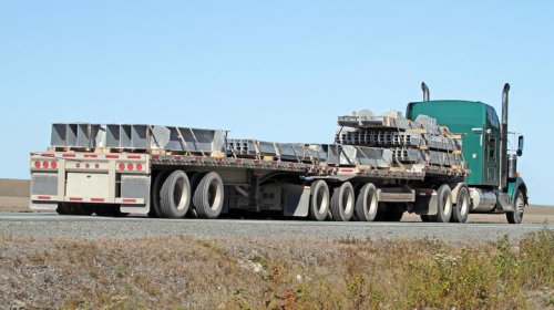 Why do some semi-trucks have stretched frames?