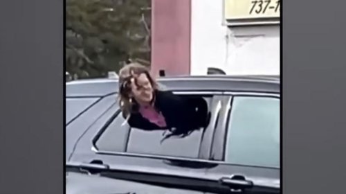 Woman gets out of tight spot by squeezing through half-open cop car window