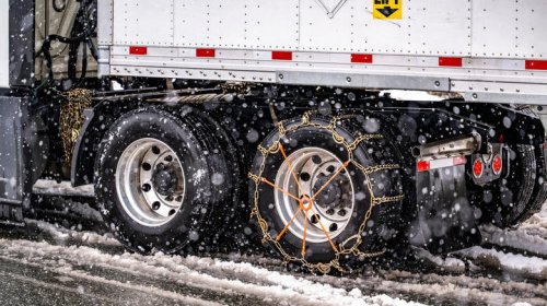 Why do most truckers choose snow chains over winter tires?