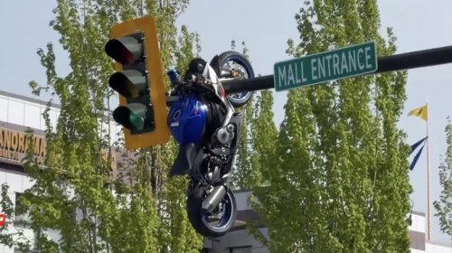 Motorcycle Hangs Out After Crash Launches It On To Street Sign