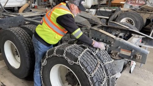 Why do most truckers choose snow chains over winter tires?