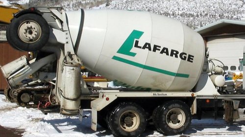 Why do some cement trucks have extra wheels at the top?