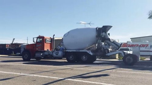 Why do some cement trucks have extra wheels at the top?