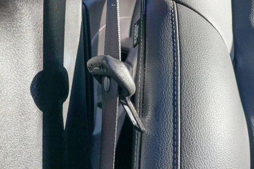 Here’s What That Little Button on Your Seat Belt Is For