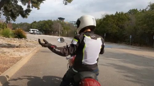 What Does It Mean When A Biker Has Their Left Palm Facing Up And Swings It Upwards?