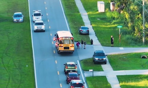When can you legally pass and stopped school bus?