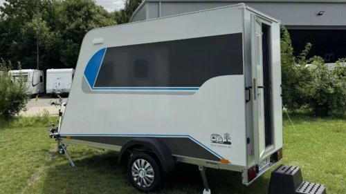 This tiny trailer hides a full camper experience inside – including a lounge and dining area