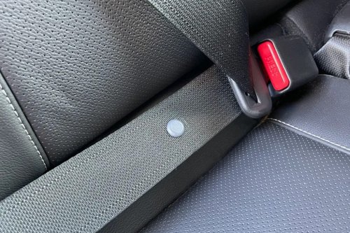 Here’s What That Little Button on Your Seat Belt Is For