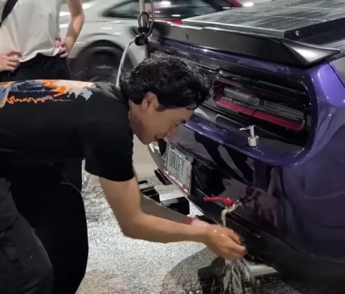 Dodge, Dodge Challenger, Man Showers at an F1 Circuit Using a Dodge Challenger's Trunk — There's Also a Stove on the Hood