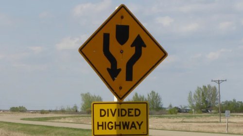 What Does A Road Sign With Two Arrows Pointing Downward Mean?
