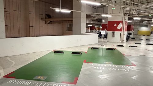 Building gives EVs and hybrids the best spots with no chargers, and commenters ask why